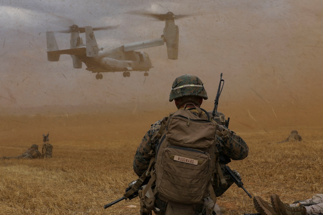 A U.S. Marine watches an MV-22B Osprey land at a landing zone during a tactical recovery of aircraft and personnel in Albacete, Spain, July 9.