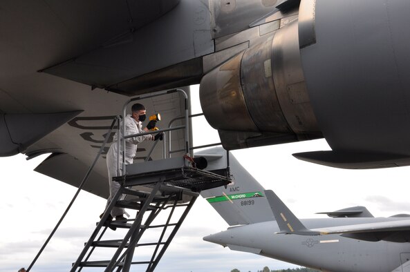 Airman inspect aircraft