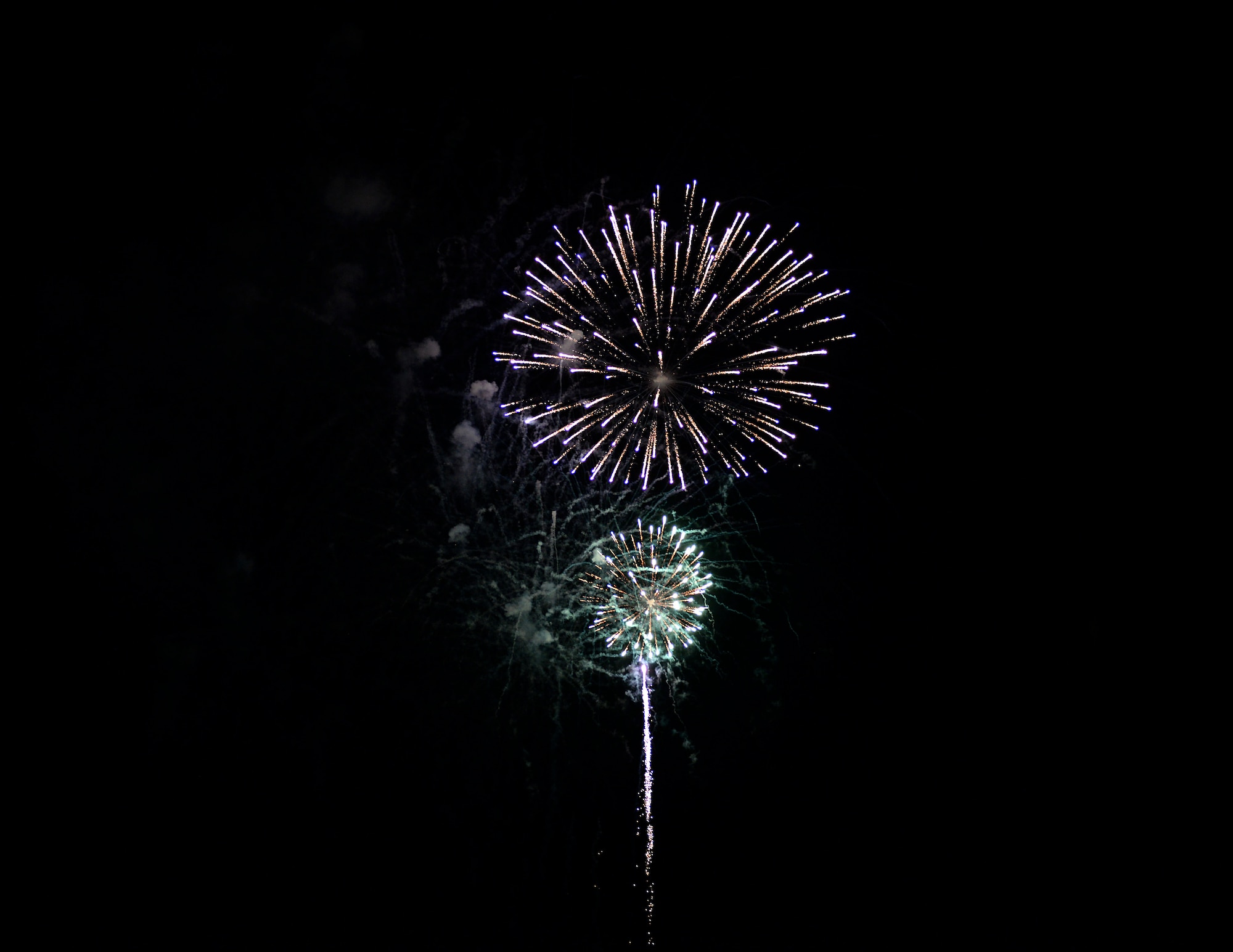 Fireworks light up the night sky over Columbus Air Force Base, Miss. during the BLAZE Fest Fireworks show, July 3, 2020. The 20-minute fireworks show was livestreamed on Facebook live to allow as much participation in the Independence Day holiday while practicing safe social distancing procedures. (U.S. Air Force photo by Airman 1st Class Hannah Bean)