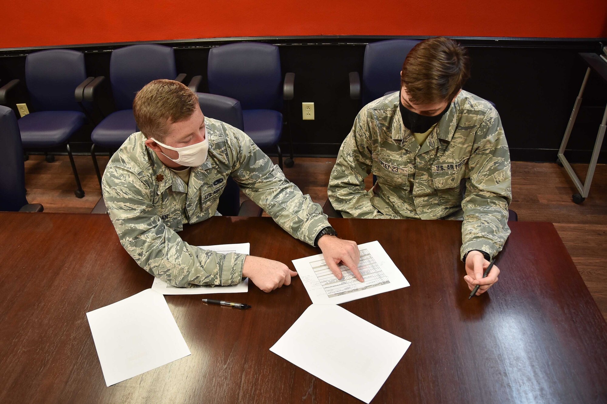 U.S. Air Force Maj. Kelly Ryan, 301st Fighter Wing Aircraft Maintenance Squadron maintenance operations officer, reviews a flight schedule with U.S. Air Force Academy Cadet 3rd Class Bennett Copley, July 8, 2020 at U.S. Naval Air Station Joint Reserve Base Fort Worth, Texas. Copley is interning as part of the USAFA Cadet Internship Program with the 301 FW Maintenance Group and shadowing the 301 FW AMXS before he heads back to the USAFA for his junior year. (U.S. Air Force photo by Senior Airman Kedesha Pennant)