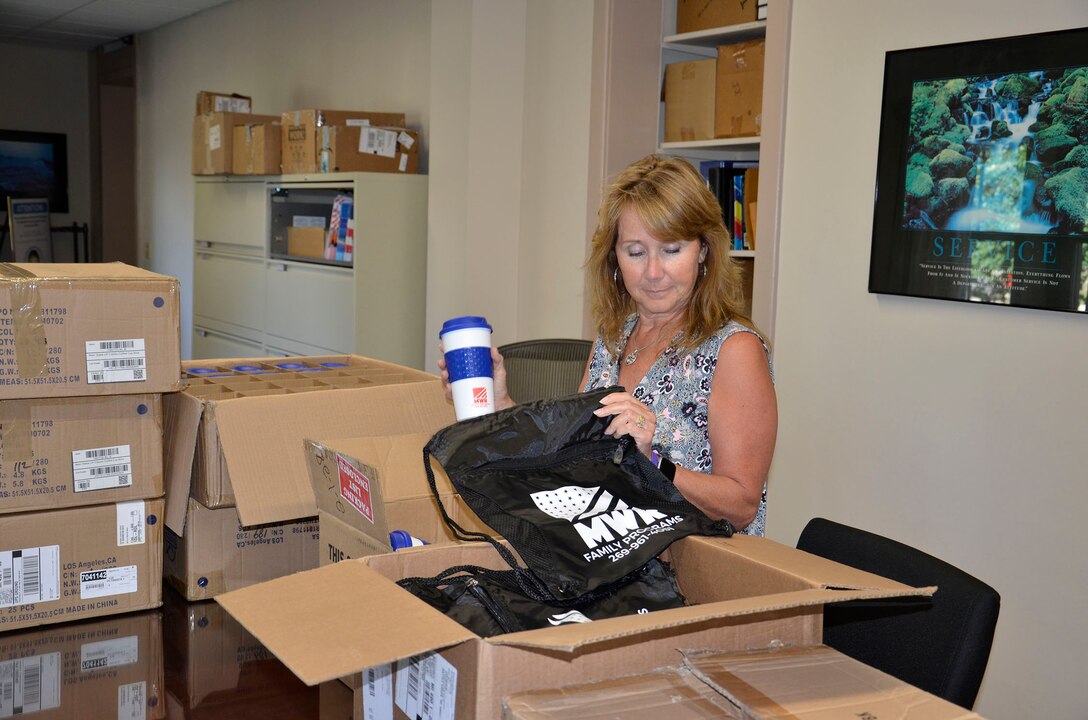 Family Services Program Manager Lisa Grenon prepares a care package for DLA Disposition Services personnel at Kandahar, Afghanistan.