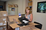 Family Services Program Manager Lisa Grenon prepares a care package for DLA Disposition Services personnel at Kandahar, Afghanistan.