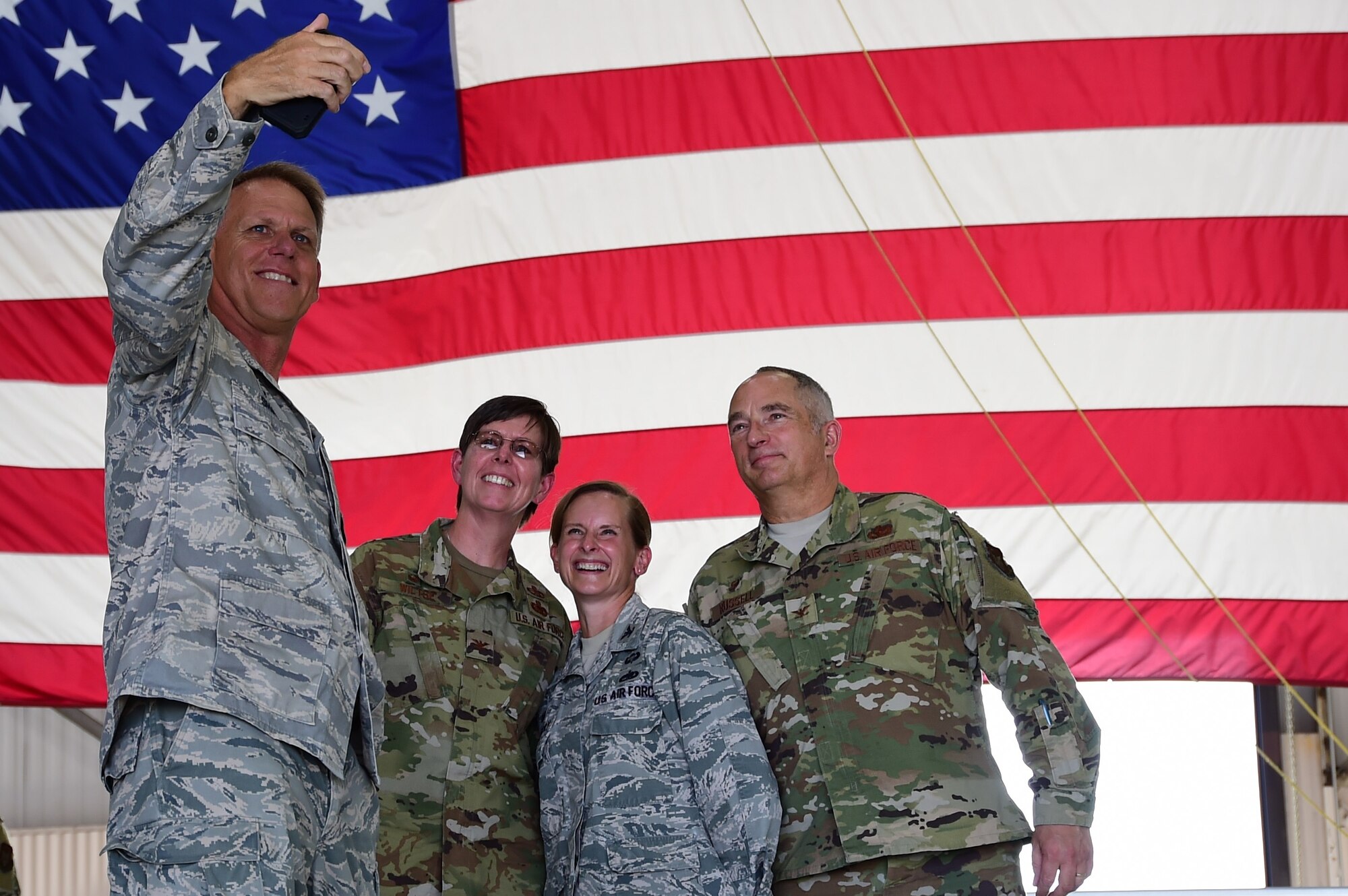 Col. Larry Shaw, 434th Air Refueling Wing commander, takes a selfie with Col. Gretchen Wiltse, 434th Mission Support Group commander, Col Arianne Mayberry 434th Maintenance Group commander and former 434th MSG commander, Col Scott Russel during a change of command ceremony at Grissom Air Reserve Base, Indiana July 9, 2020. (U.S. Air Force photo/SSgt Chris Massey)