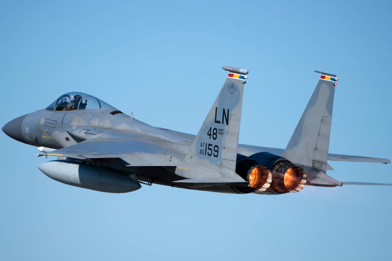 A fighter jet soars in the sky.