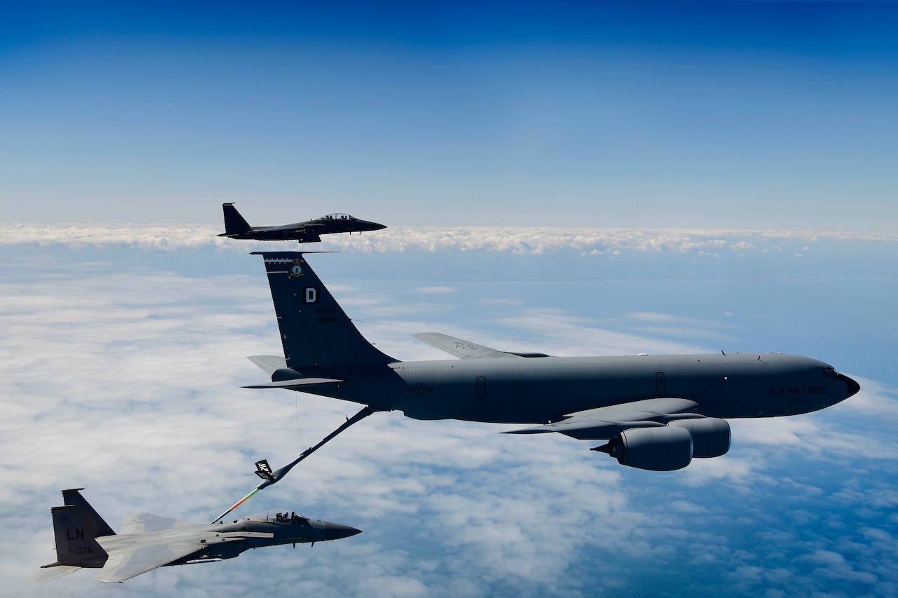 An aircraft is refueled in mid-air.