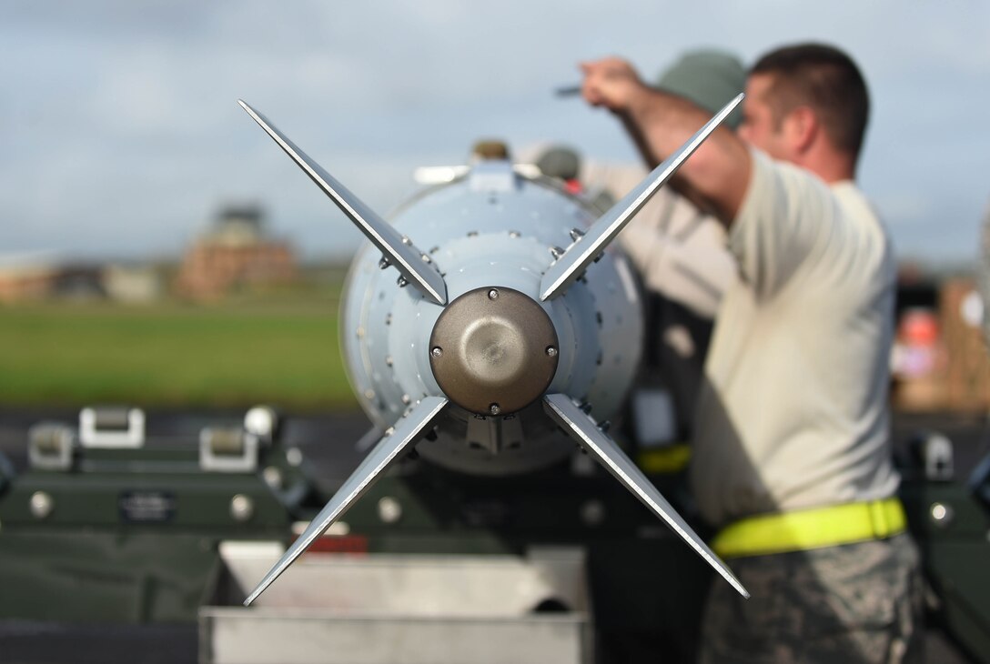 An airman works on a munition.