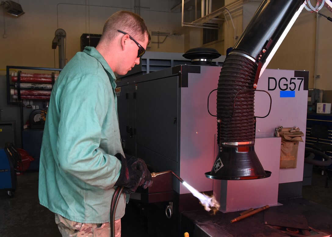 Senior Airman Jay Powell, 22nd Maintenance Squadron metals technology journeyman, starts an oxygen acetylene torch July 9, 2020, at McConnell Air Force Base, Kansas. The torch mixes compressed oxygen with acetylene gases to produce temperatures high enough to make metal malleable. (U.S. Air Force photo by Airman 1st Class Marc A. Garcia)