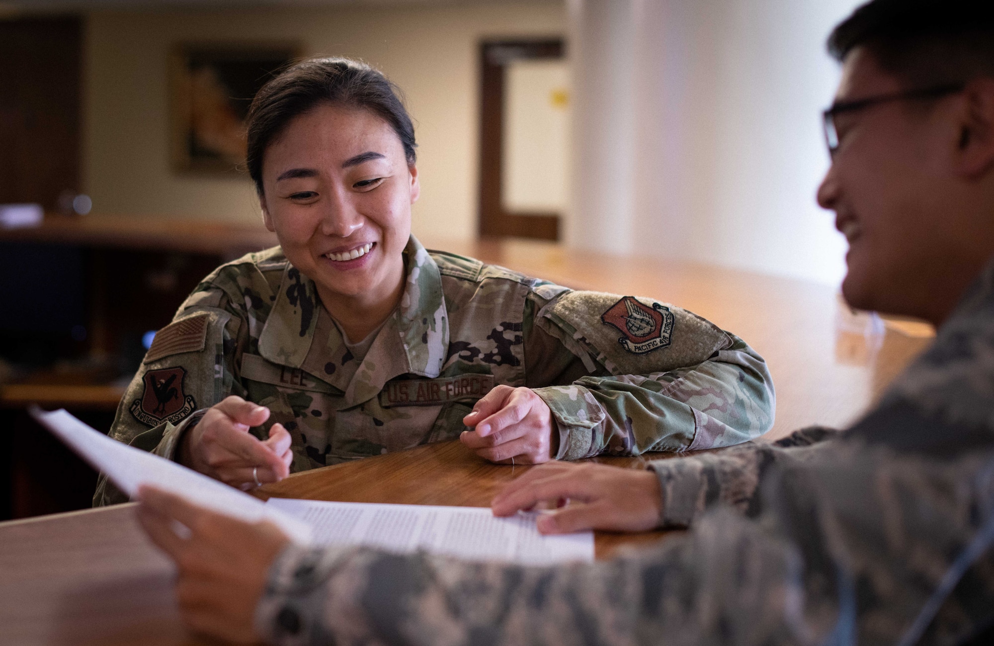 1st Lt. Susan S. Lee, explains the legal handouts detailing overview information for specific cases, helping agencies, and other legal steps that customers must know before taking action on Kadena Air Base.
