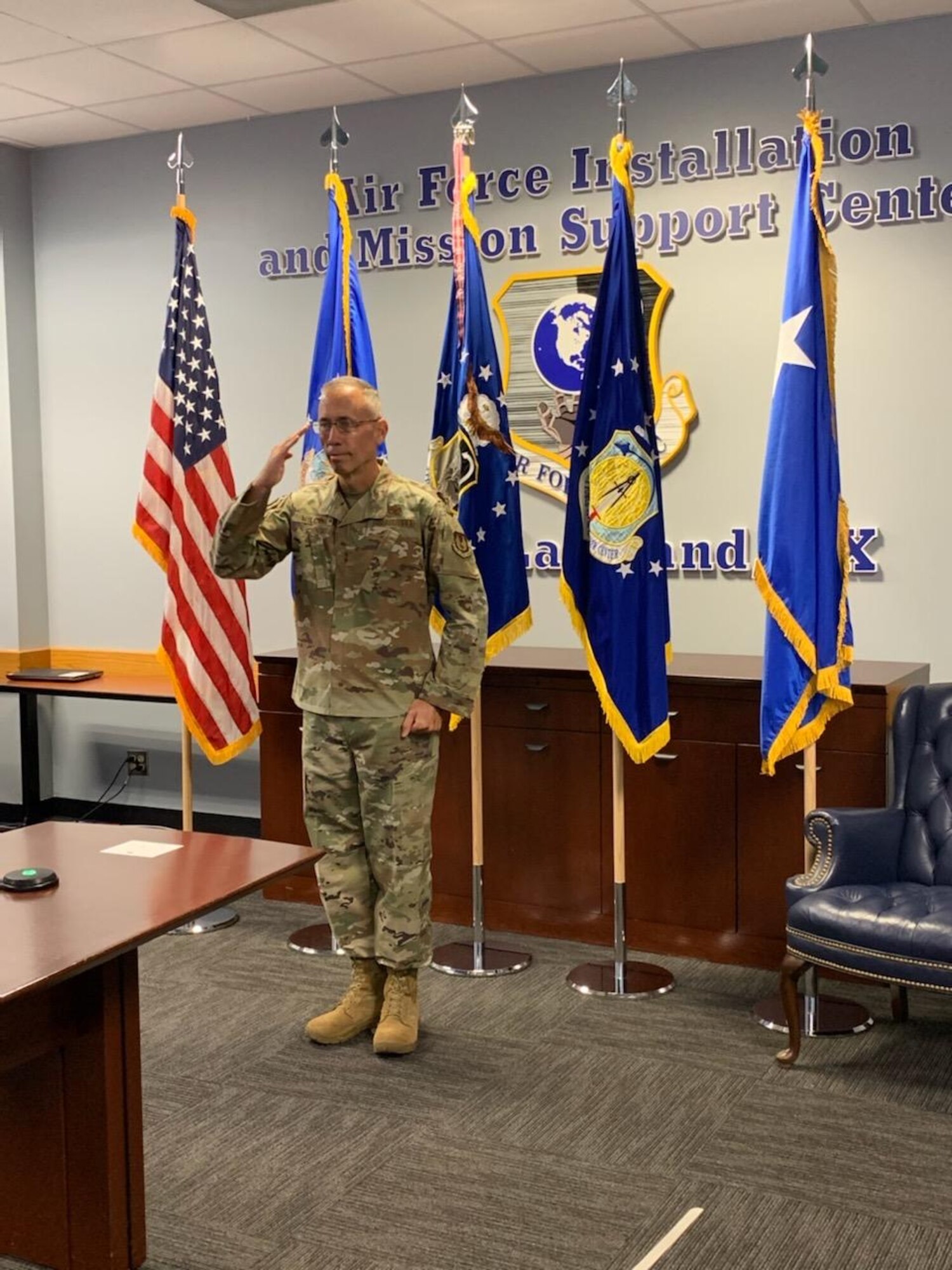 Photo of Maj. Gen. Tom Wilcox saluting.