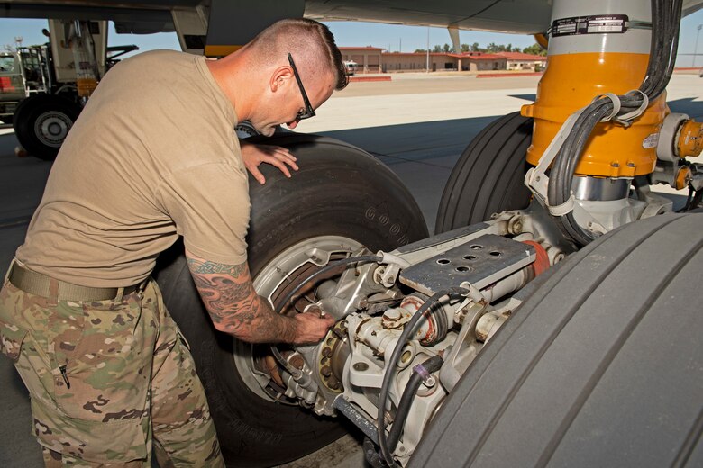 photos of an airman checking a KC-10 Globemaster aircraft
