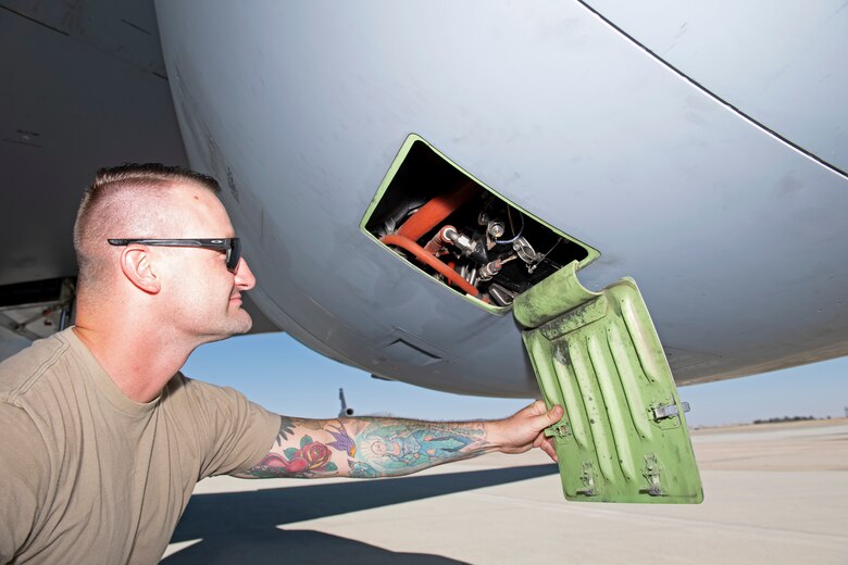 photos of an airman checking a KC-10 Globemaster aircraft