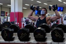 U.S. Marine Corps Cpl. Avery Luengo, a communications Marine with Headquarters and Support Battalion, Marine Corps Installations Pacific - Marine Corps Base Camp Smedley D. Butler, performs military presses at Gunner's Gym, Camp Foster, Okinawa, Japan. Luengo, like every gym-goer at fitness centers across Marine Corps installations in Okinawa, practices mitigation procedures to protect the force against COVID-19. (Marine Corps photo by Staff Sgt. Lucas Vega)