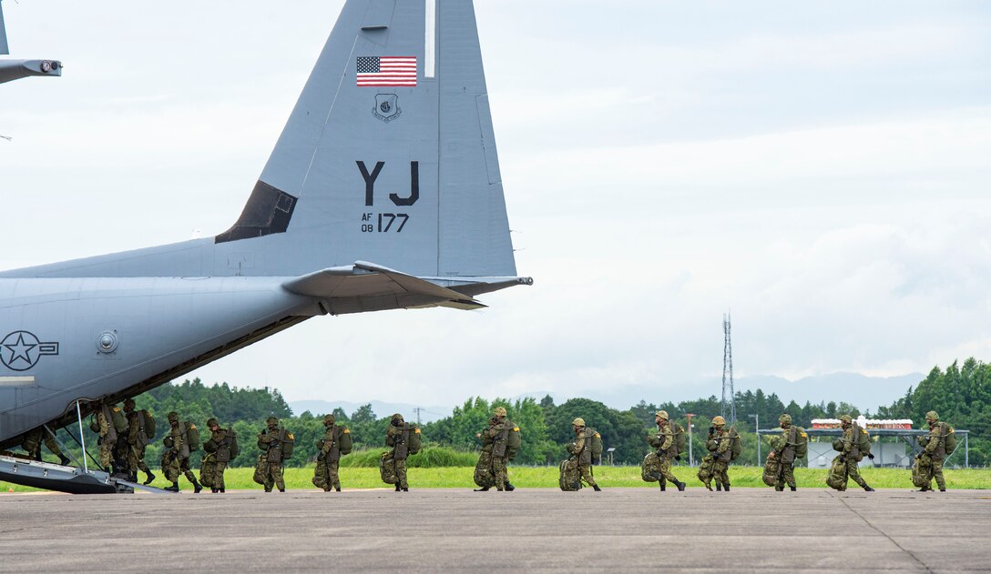 Japan Ground Self Defense Force paratroopers board a C-130J Super Hercules