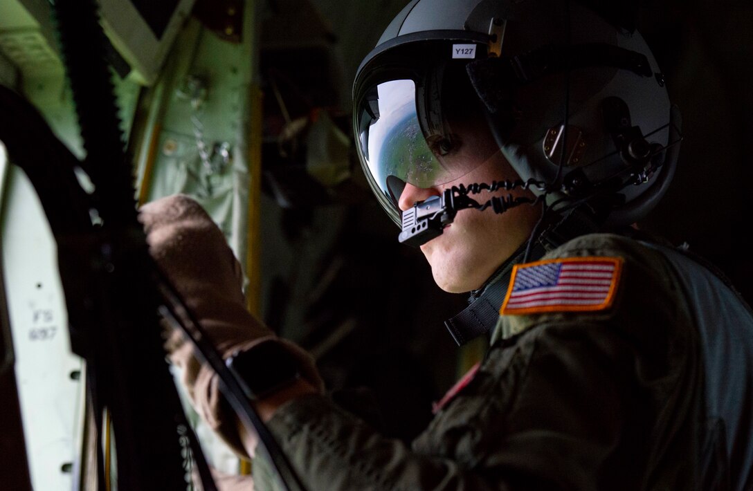 Senior Airman John Allum, 36th Airlift Squadron loadmaster, scans the terrain near the Ojoji drop zone