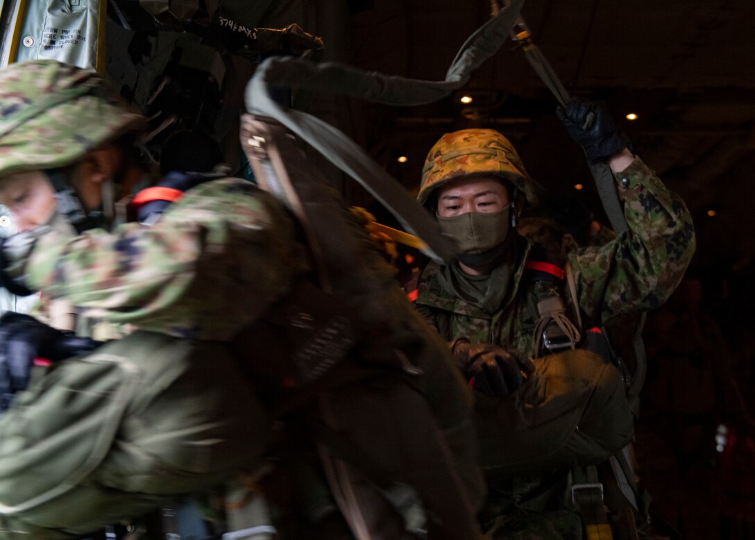 Japan Ground Self Defense Forces paratroopers jump out of a C-130J Super Hercules, assigned to the 374th Airlift Wing, Yokota Air Base