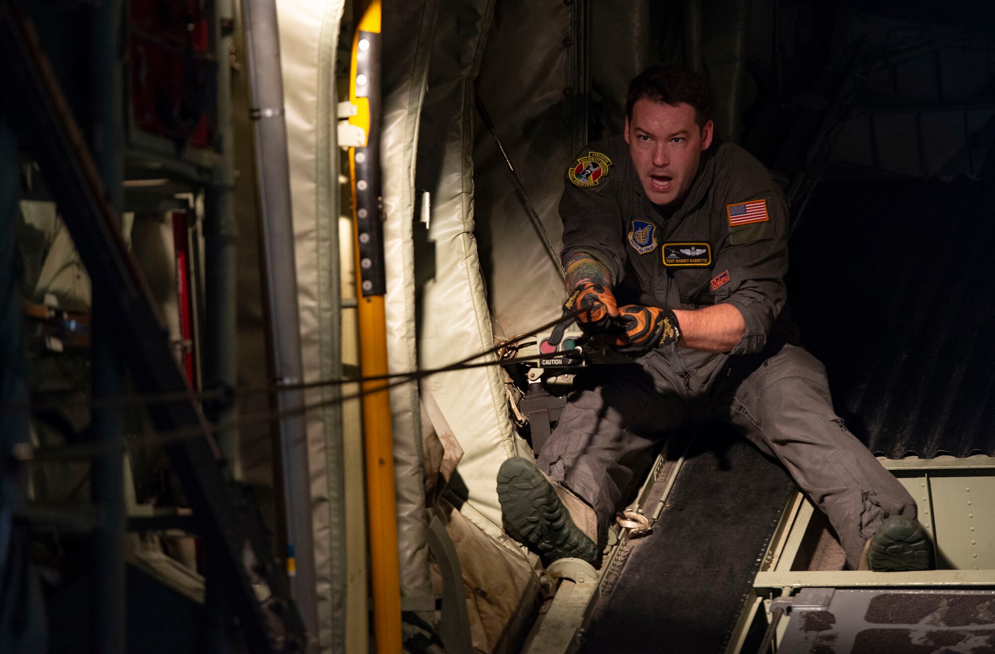 Tech. Sgt. Barney Barnette, 36th Airlift Squadron loadmaster, prepares a static line