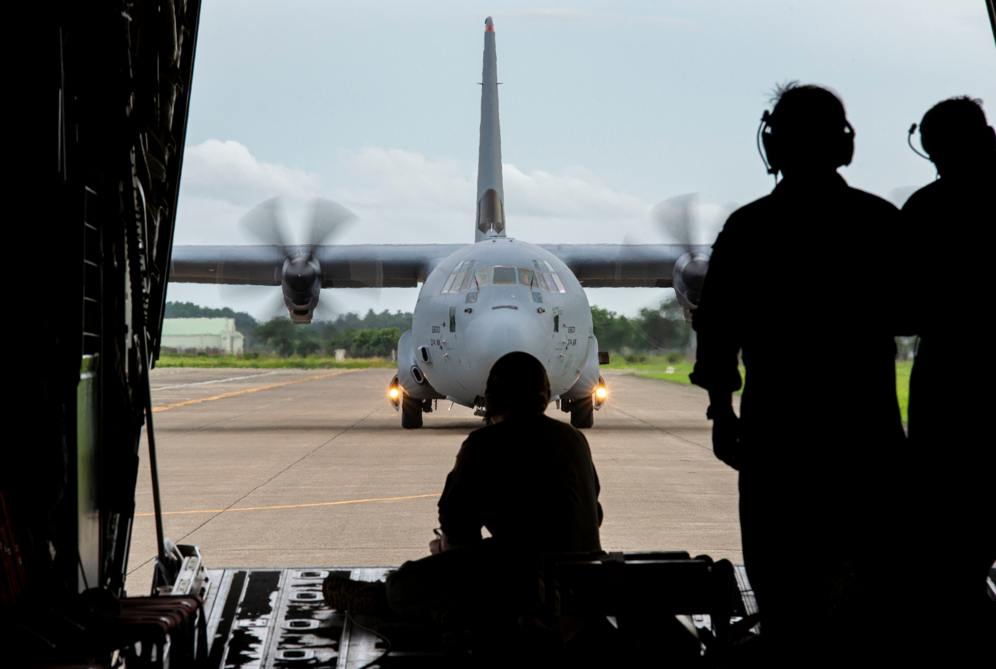 Loadmasters with the 36th Airlift Squadron watch a C-130J Super Hercules taxi at Hyakuri Air Base