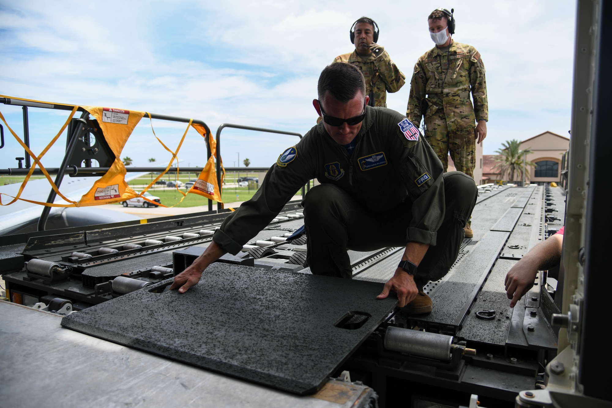 Senior Master Sgt. Aaron McLaughlin, 18th Air Refueling Squadron inflight refueler assigned to McConnell Air Force Base, Kansas places a cargo loader bridge plate prior to patient offload July 11, 2020, at Patrick Air Force Base, Florida. In preparation for the first operational aeromedical evacuation mission, three separate aeromedical evacuation’s were simulated to help determine the usability of medical equipment, capacity of patients and proper aircraft staging. (U.S. Air Force photo by Airman 1st Class Nilsa Garcia)