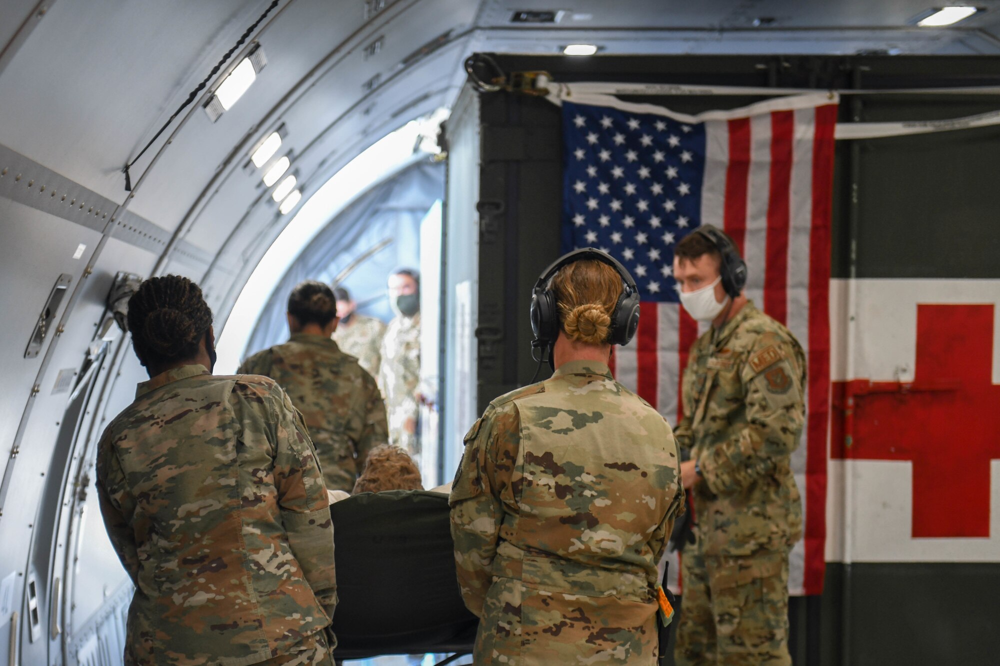 Photo of Airmen offloading a non-ambulatory patient