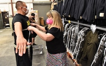 a male Soldier is measured by a tailor to be fitted for the new Army uniform.