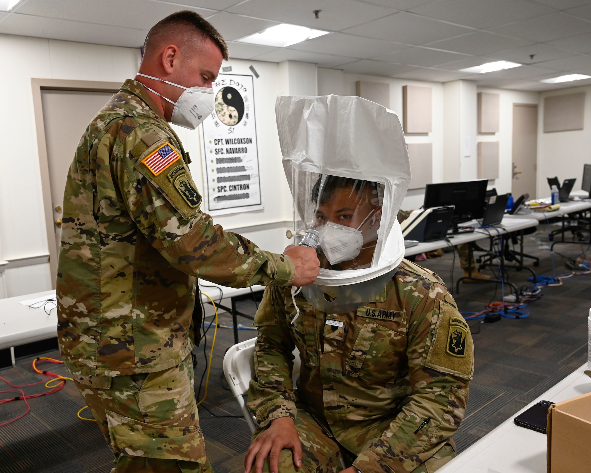 A member of the Connecticut Army National Guard gets fitted for a Tyvek suit in preparation for long-term care facility safety inspections, June 17, 2020, Hartford, Connecticut. The inspections, which were part of Connecticut's COVID-19 pandemic response, were conducted by teams of Connecticut National Guardsmen and DPH surveyors. (U.S. Air Natitonal Guard photo by Tech Sgt. Tamara R. Dabney)