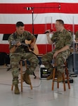 Two members of the 132nd Army Band’s Rock Band play for people working at Joint Force Headquarters during an Independence Day celebration in Madison, Wis., July 7, 2020.