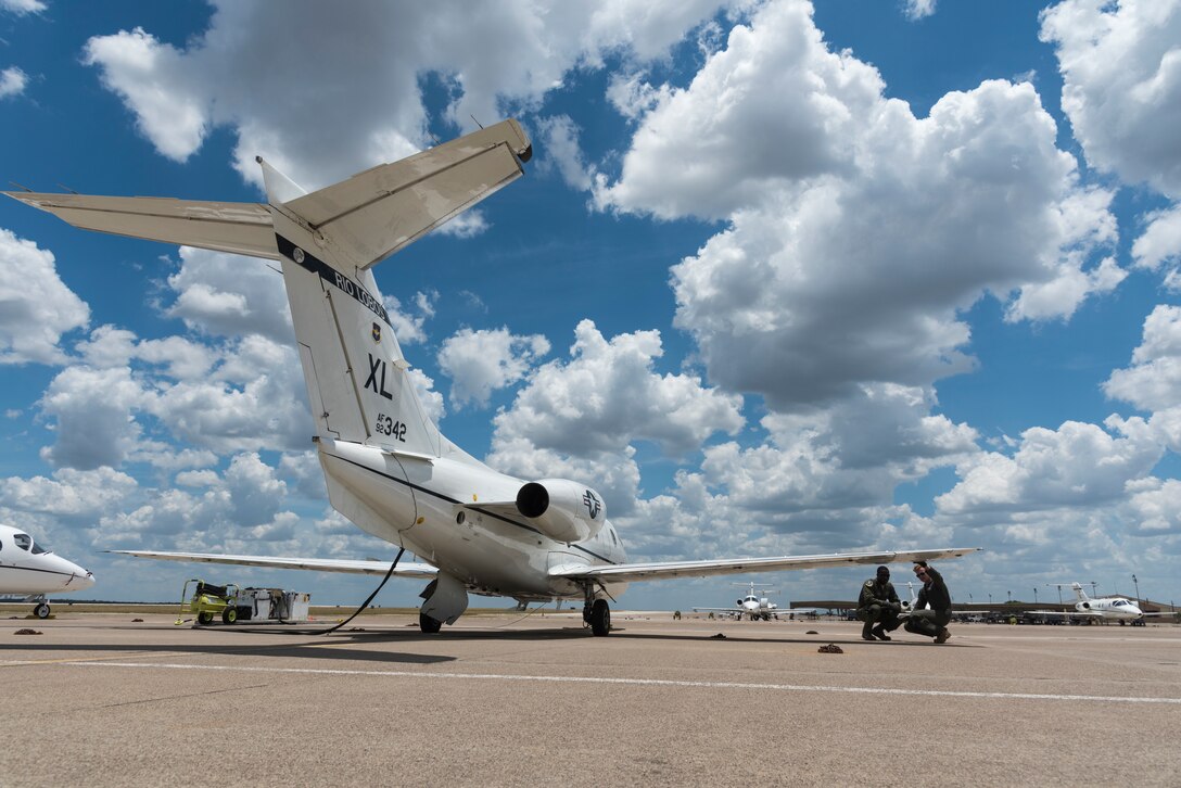 Capt. Jarod Washington, 86th Flying Training Squadron instructor pilot, and 2nd Lt. Jake Marino, 47 Student Squadron student pilot, walk through a pre-flight inspection before a flight in a T-1A Jayhawk, June 25, 2020 at Laughlin Air Force Base, Texas. Lt. Col. Shawn Chaney, 86th FTS director of operations, says he prides his squadron in the way they cultivate a passion for teaching Specialized Undergraduate Pilot Training.  (U.S. Air Force photo by Senior Airman Anne McCready)