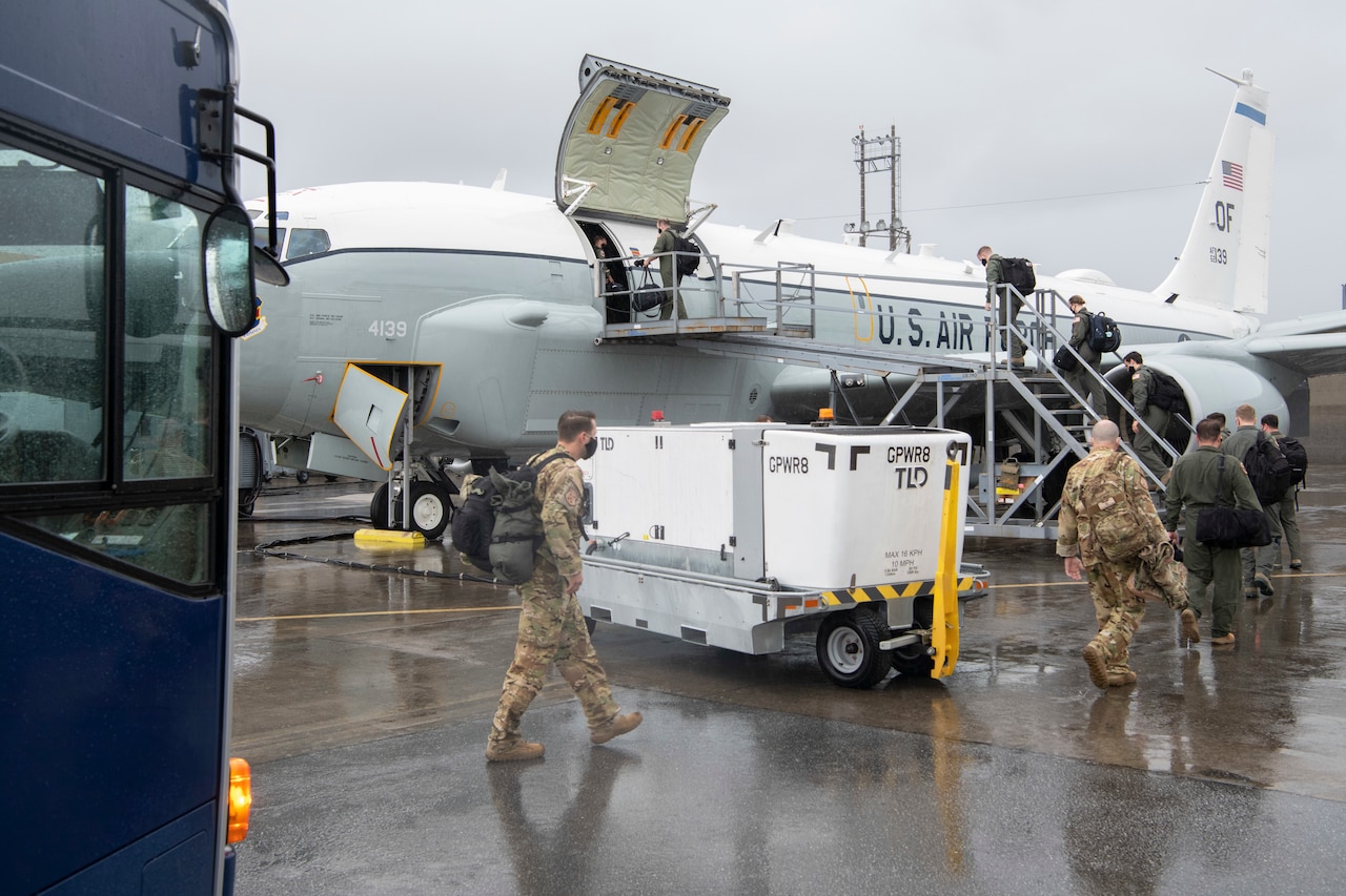 Airmen board an airplane.
