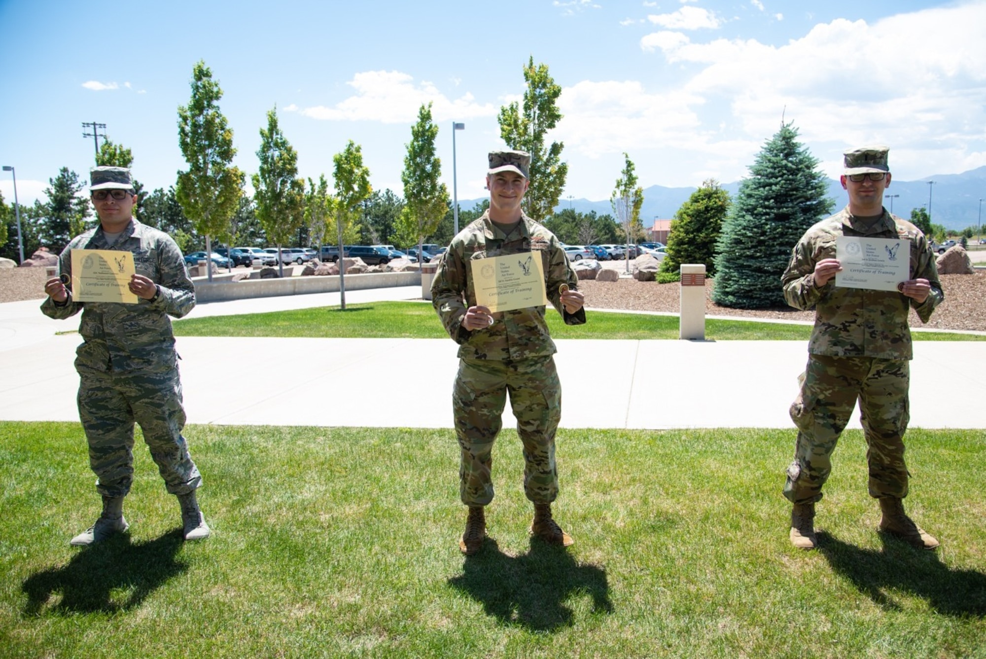 PETERSON AIR FORCE BASE, Colo. – Space Warfighter Follow-on course students, Airman 1st Class Nathaniel Guerrero, left, 2nd Lt. Austin Grant, center, and 1st Lt. Joshua Lewis, right, showcase their training certificates and coins awarded for graduating as top performers from their respective SWF courses during the SWF course graduation at Peterson Air Force Base, Colorado, June 12, 2020. SWF leads selected top performers based on their outstanding academic performance and exemplary contribution to their class, with Guerrero graduating from Space Electronic Warfare, Grant graduating from Space Battle Management and Lewis graduating from Orbital Warfare. (U.S. Space Force photo by 2nd Lt. Idalí Beltré Acevedo)