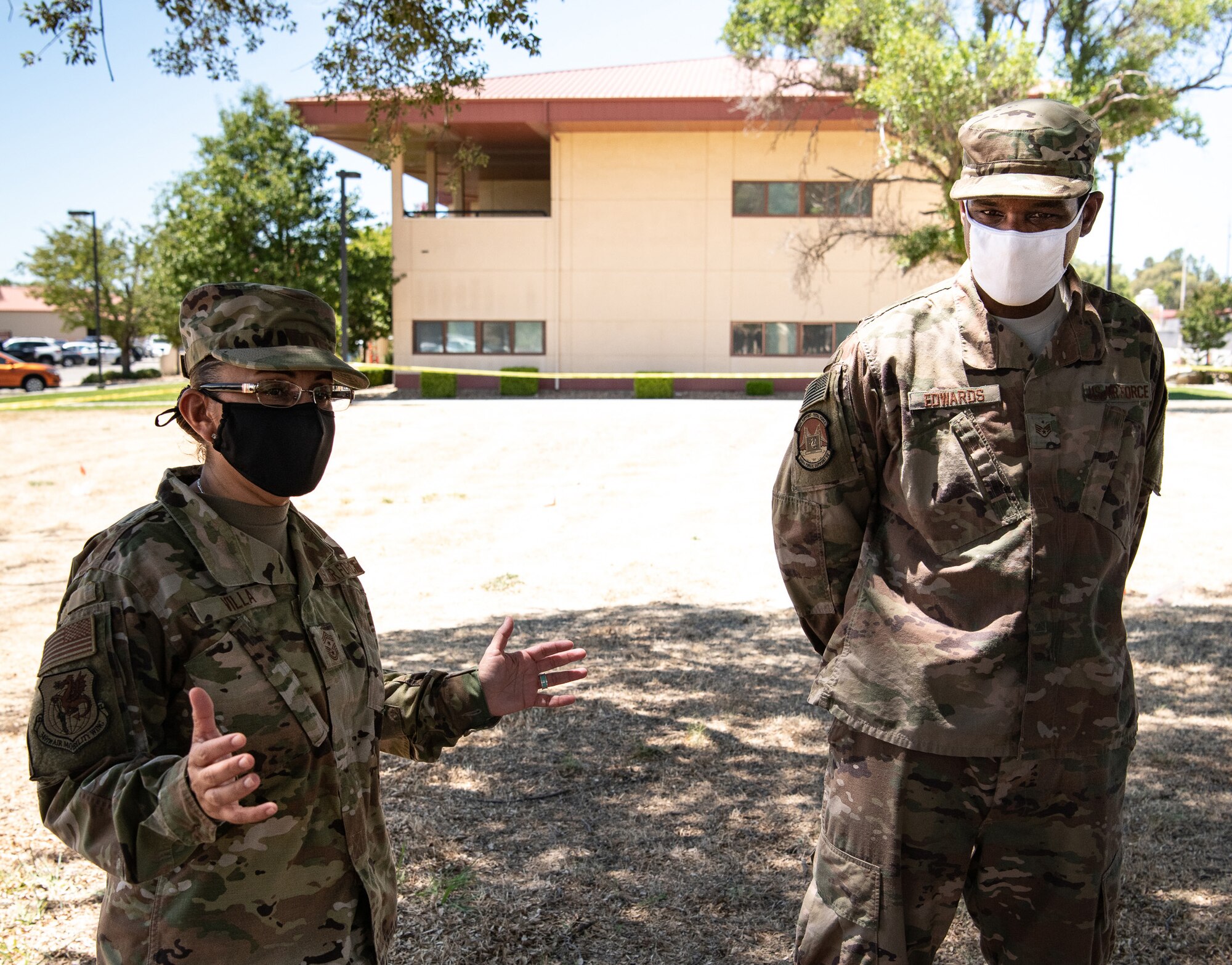 Fourth Air Force Command Chief Master Sgt. Cynthia Villa visits with 349th Force Support Squadron Airmen as they complete training in a crash recovery situation. Staff Sgt. Diontae L. Edwards, 349th FSS stands by to assist the Command Chief during the visit.