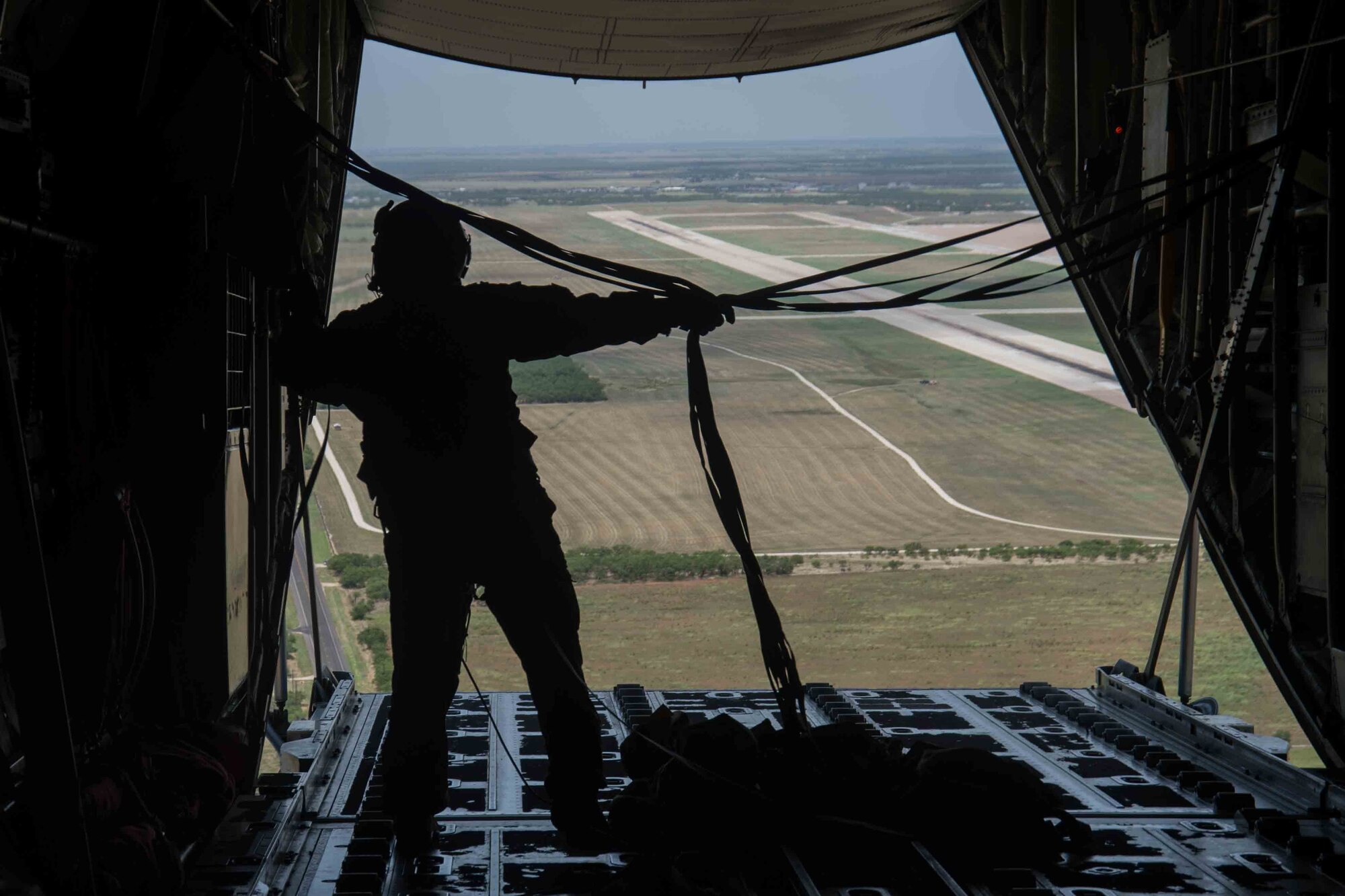 Master Sgt. Lynzey Thornton, 39th Airlift Squadron loadmaster, gathers cords after a simulated cargo drop during a Joint Forcible Entry exercise July 14, 2020, in Dyess AFB, Texas.