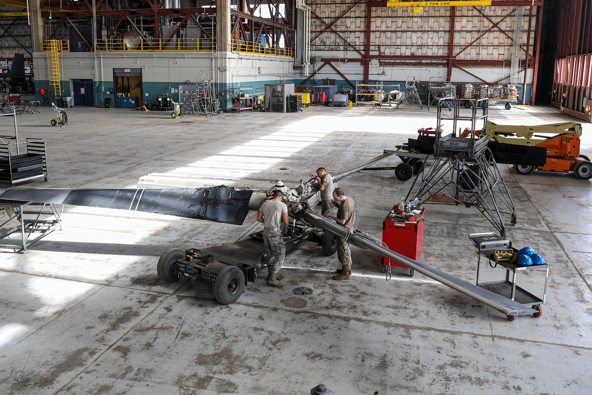 Maintainers work on CV-22 Osprey propeller blades.
