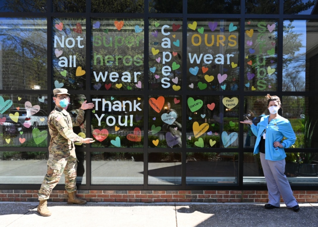 Army 2nd Lt. Justin Lee, a platoon leader assigned to the 104th Medical Company Area Support, Maryland National Guard, poses April 9, 2020, with Celia Goughenour, the director of nursing for Crofton Care and Rehabilitation Center in Crofton, Maryland.