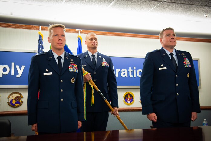 Col. Robert Henderson, out-going 635th Supply Chain Operations Wing commander, relinquishes command of the wing to Col. Chad Ellsworth, in-coming 635th SCOW commander, during a change of command ceremony at Scott Air Force Base, Illinois, July, 10, 2020.