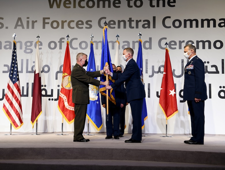 U.S. Air Force Lt. Gen. Gregory Guillot, incoming commander of U.S. Air Forces Central Command, accepts command from U.S. Marine Corps Gen. Kenneth McKenzie, commander of U.S. Central Command, during a change of command ceremony at Al Udeid Air Base, Qatar, July 16, 2020.
