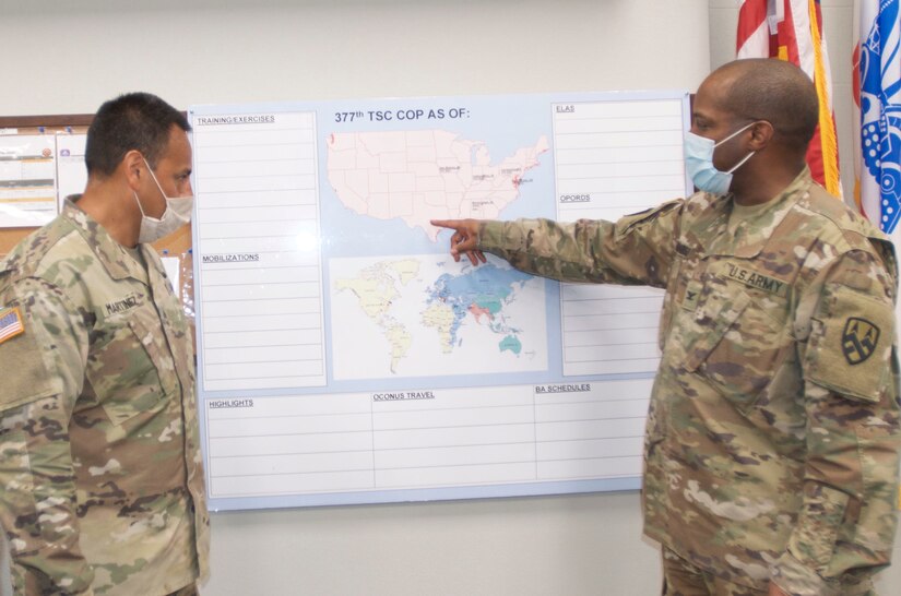 Col. Reggie Richardson (right), the 377th Theater Sustainment Command Deputy Chief of Staff, reviews recent coronavirus activity with Sgt. 1st Class Edward Martinez,  support operations noncommissioned officer in charge of supply and services, at the command headquarters in Belle Chasse, La.
