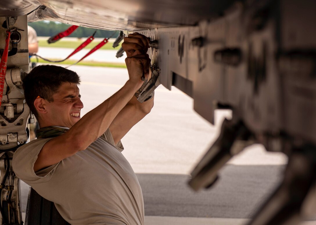 Airman 1st Class Elijah Nolan, 333rd Aircraft Maintenance Unit weapons load crew member, prepares the weapons rack of an F-15E Strike Eagle at Seymour Johnson Air Force Base, North Carolina, July 10, 2020.