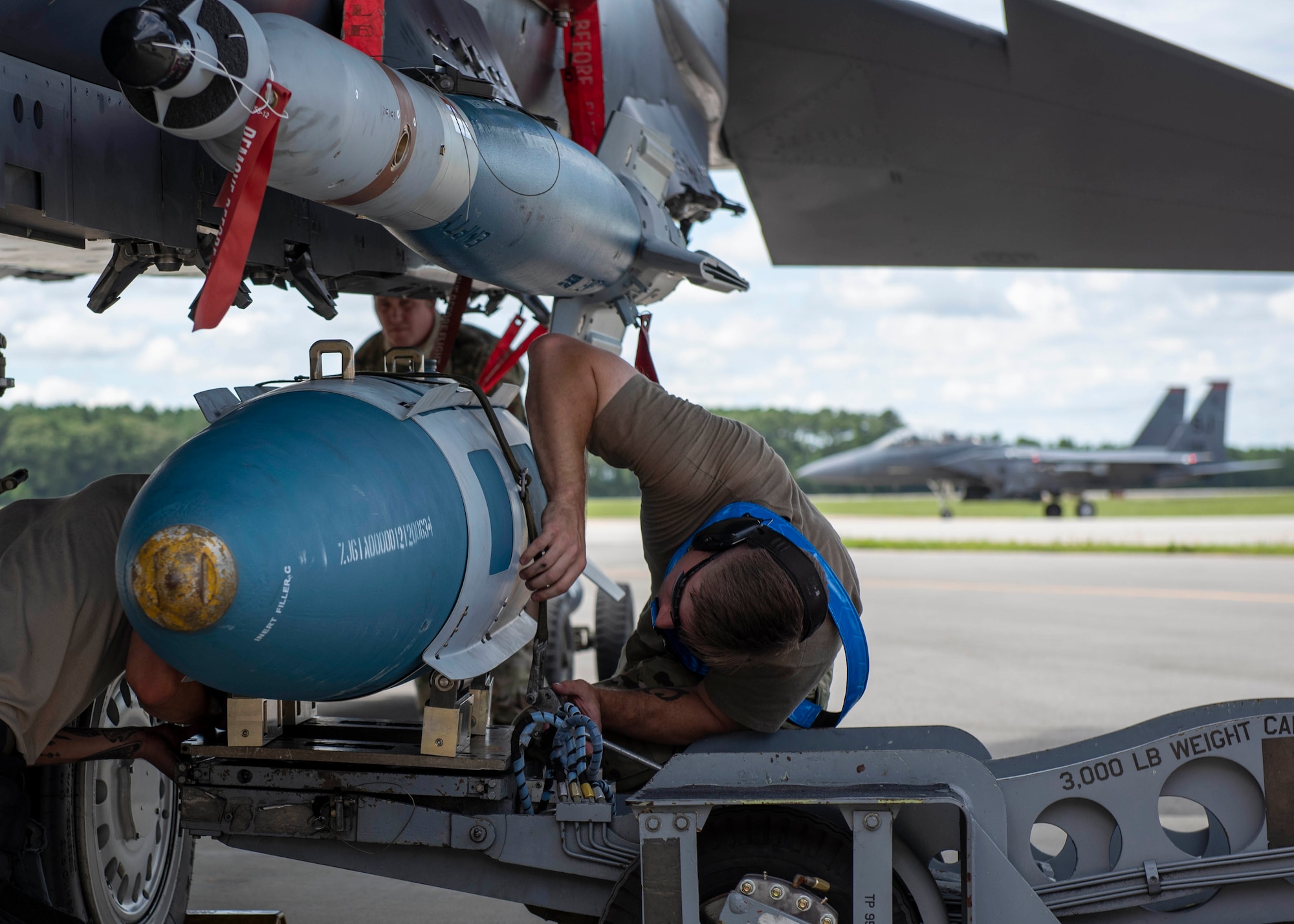Senior Airman Christian Tate, 333rd Aircraft Maintenance Unit weapons load crew member, prepares to load a Guided Bomb Unit-31 onto an F-15E Strike Eagle during a quarterly load crew competition at Seymour Johnson Air Force Base, North Carolina, July 10, 2020.