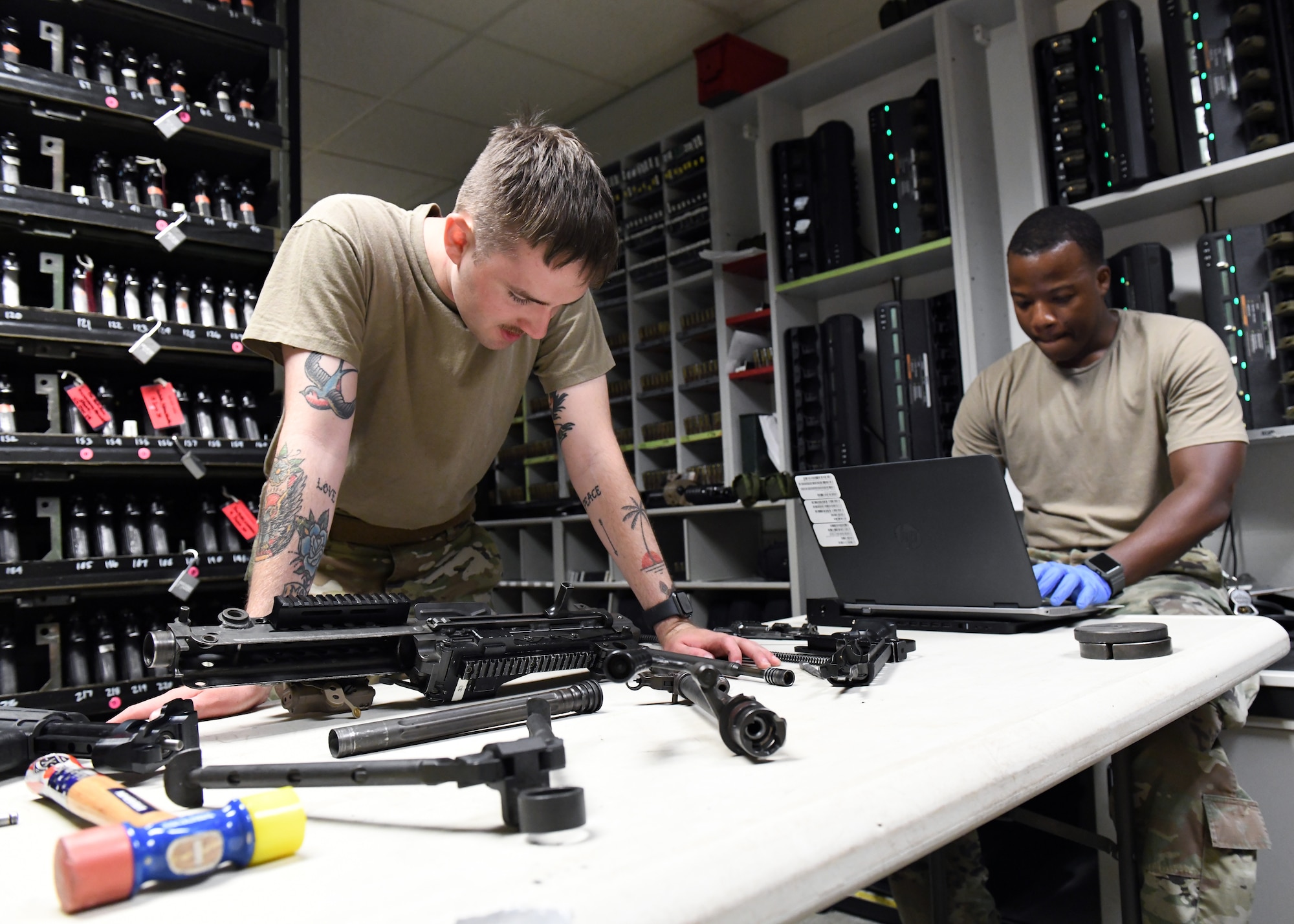 Senior Airman Richard Mitchell, 9th Security Forces Squadron combat arms instructor (left), and Staff Sgt. Ansumana Turray, 9th SFS assistant NCOIC of combat arms, conduct a weapon inspection at the Security Forces armory, June 26, 2020, at Beale Air Force Base California. Combat arms instructors ensure all Recce Town weapons are in working condition. (U.S. Air Force photo by Airman 1st Class Luis A. Ruiz-Vazquez)