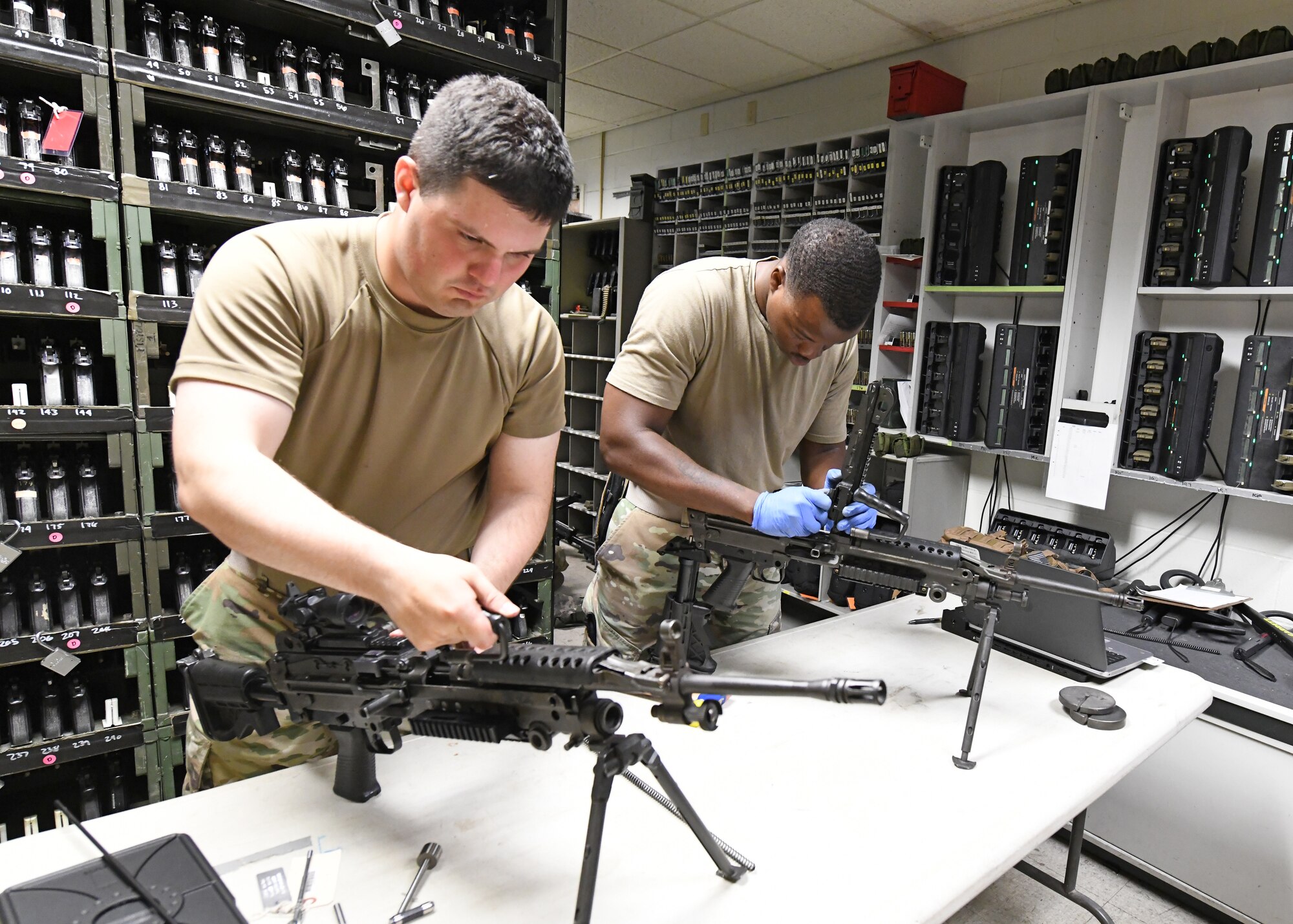 Senior Airman Keith Talbot, 9th Security Forces Squadron combat arms instructor (left), and Staff Sgt. Ansumana Turray, 9th SFS assistant NCOIC of combat arms, inspect M249 Light Machine Guns, June 26, 2020, at Beale Air Force Base California. Recce Town’s combat arms instructors conduct weapon inspections regularly to ensure they are in working condition. (U.S. Air Force photo by Airman 1st Class Luis A. Ruiz-Vazquez)