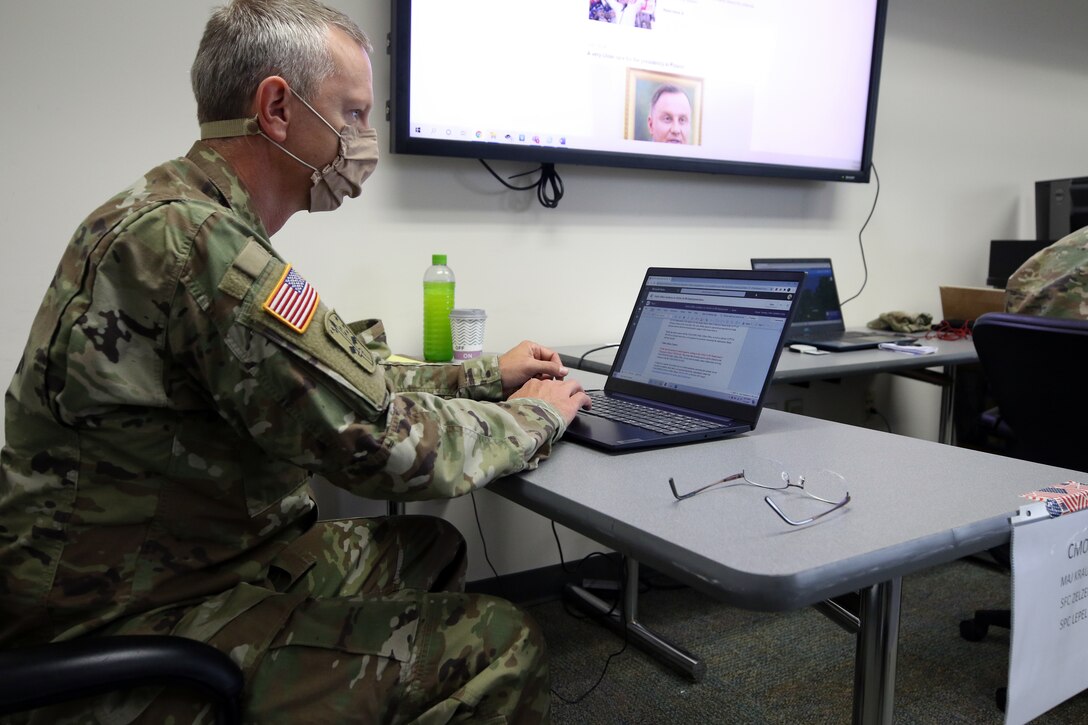 Major Tim Krause, the civil military operations center officer in charge, Charlie Company, 432nd Civil Affairs Battalion, 308th Civil Affairs Brigade, reviews information about a fictional region during a cumulative training exercise at Fort McCoy, Wis., July 14, 2020. Krause and other members of the 432nd CA Bn., are preparing for an upcoming mobilization overseas later this year.