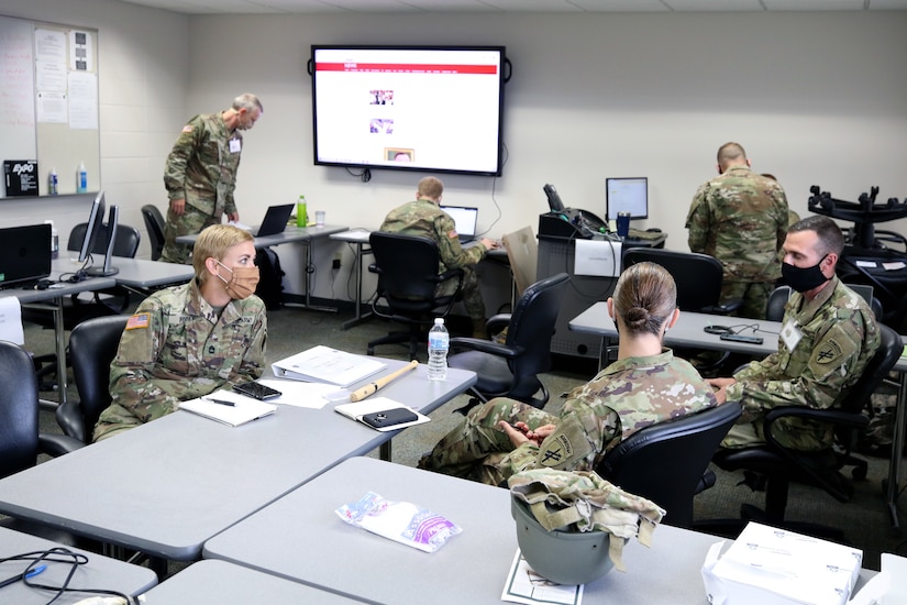 Soldiers from the 432nd Civil Affairs Battalion work at a civil military operations center as part of the cumulative training exercise July 14, 2020, in preparation for an upcoming overseas deployment. These Soldiers are some of the first to begin in-person training following the guidelines of the Centers for Disease Control and the Department of Defense.