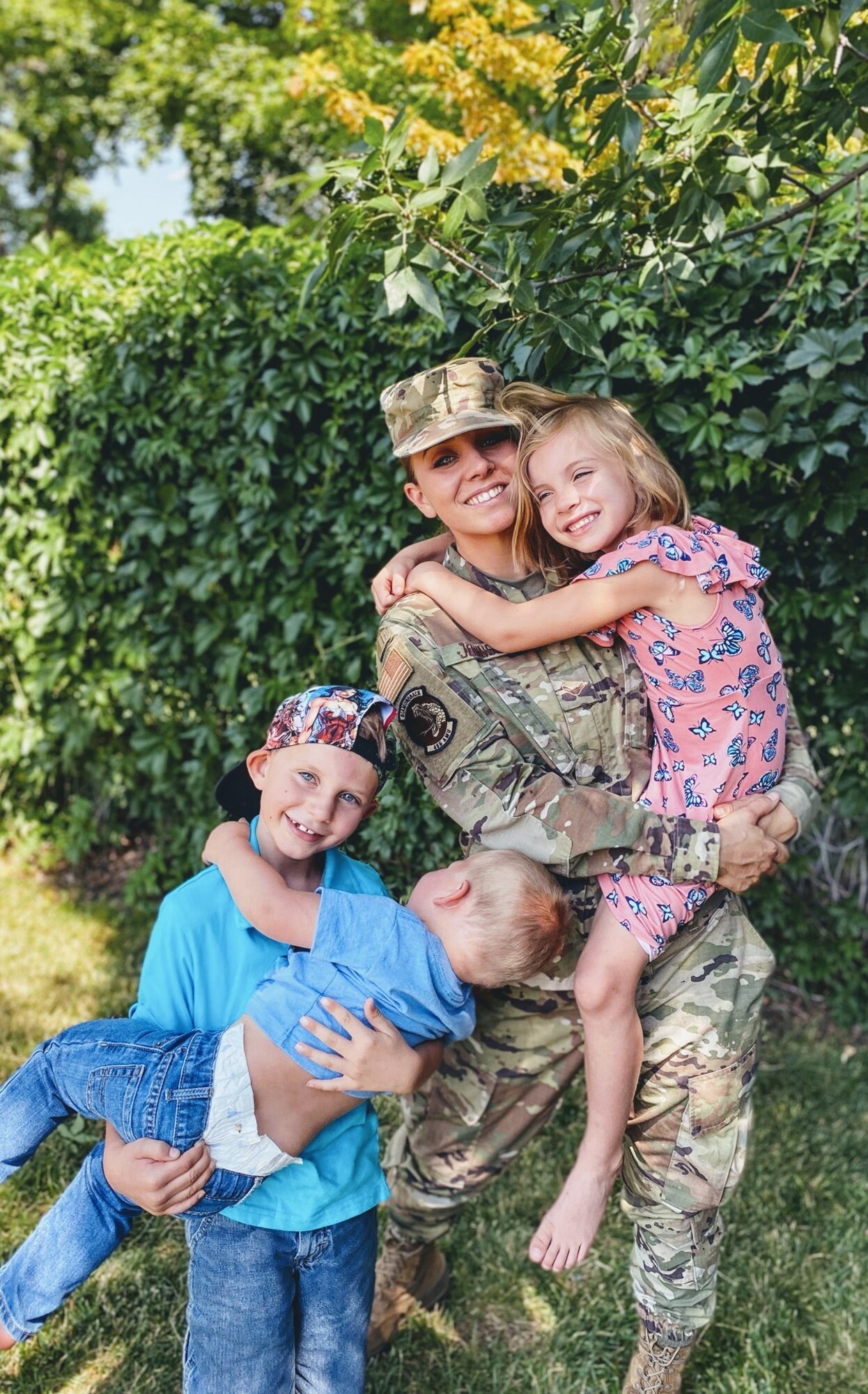 Airman 1st Class Sarah Johnson, an F-3 weapons loader, takes a moment to pose with her children