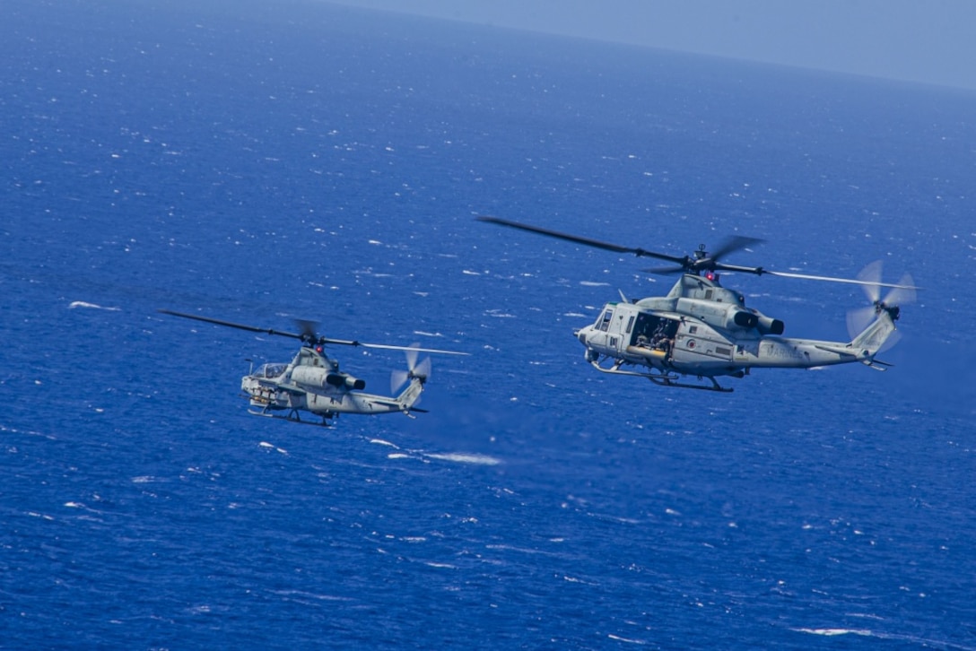 U.S. Marines with Marine Light Helicopter Attack Squadron 367 operate an AH-1Z Viper and UH-1Y Venom during a joint maritime strike exercise with U.S. Navy Helicopter Maritime Strike Squadron 37 over Pacific Missile Range Facility, Hawaii, June 9, 2020. HMLA-367 and HSM-37 conducted the training to exercise sea control and sea denial operations. (U.S. Marine Corps photo by Lance Cpl. Jacob Wilson)