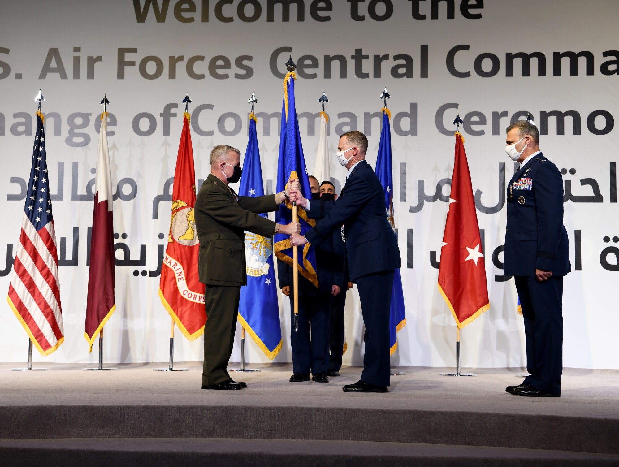 U.S. Air Force Lt. Gen. Gregory Guillot, incoming commander of U.S. Air Forces Central Command, accepts command from U.S. Marine Corps Gen. Kenneth McKenzie, commander of U.S. Central Command, during a change of command ceremony at Al Udeid Air Base, Qatar, July 16, 2020.