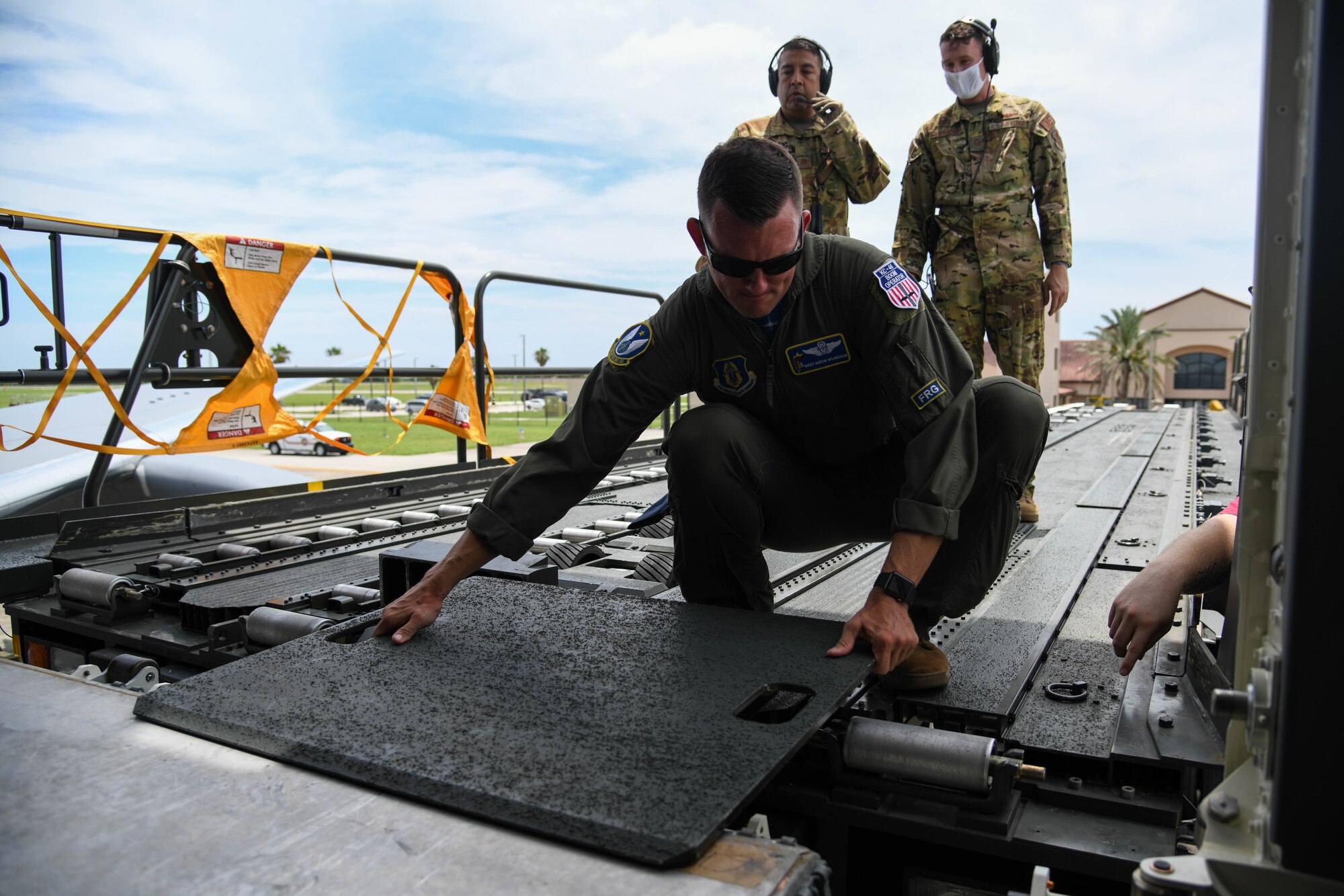 Senior Master Sgt. Aaron McLaughlin, 18th Air Refueling Squadron inflight refueler assigned to McConnell Air Force Base, Kansas places a cargo loader bridge plate prior to patient offload July 11, 2020, at Patrick Air Force Base, Florida. In preparation for the first operational aeromedical evacuation mission, three separate aeromedical evacuation’s were simulated to help determine the usability of medical equipment, capacity of patients and proper aircraft staging. (U.S. Air Force photo by Airman 1st Class Nilsa Garcia)