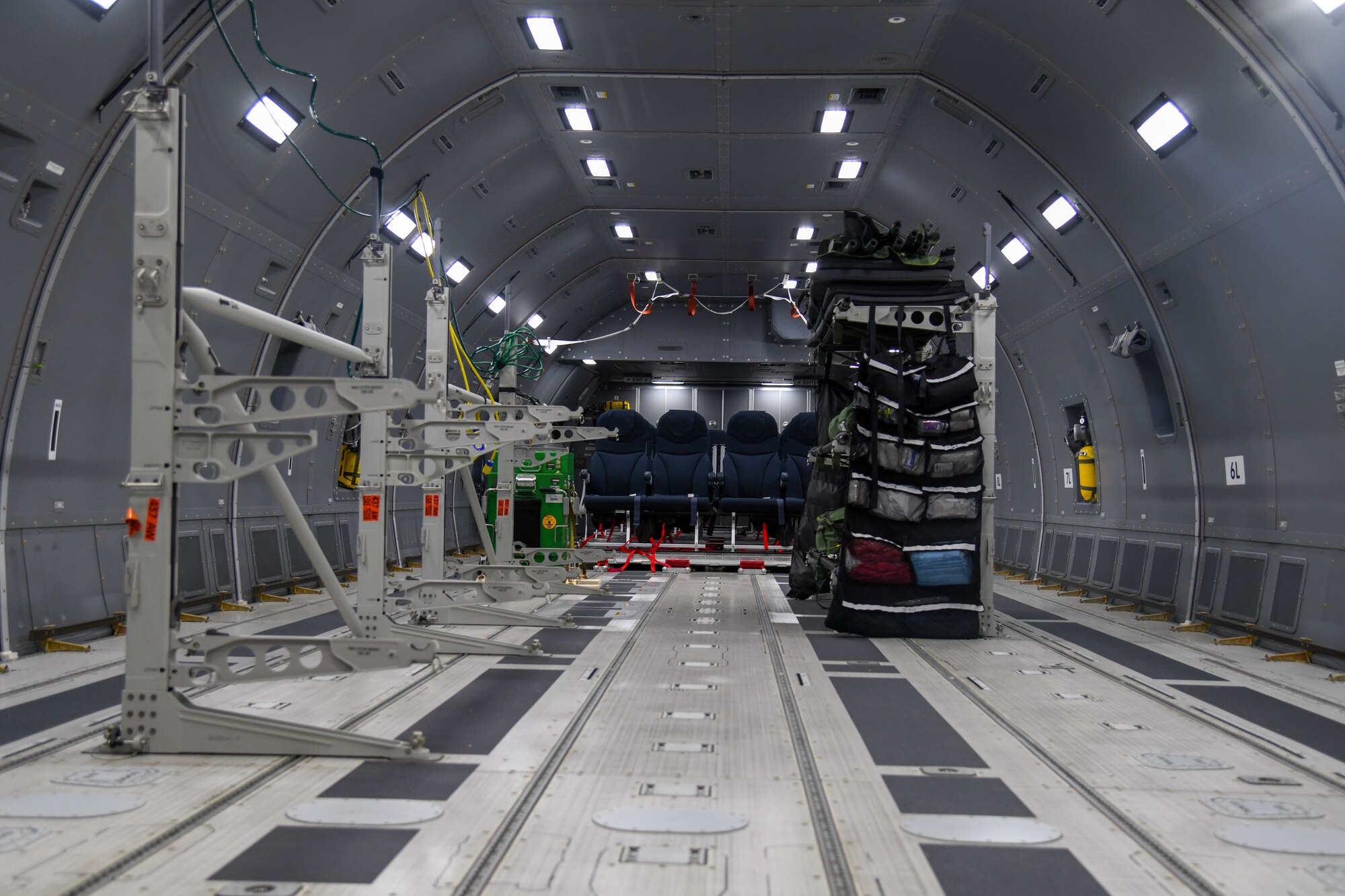 Litter stations stand assembled in the fuselage of a KC-46A Pegasus prior to patient arrival July 10, 2020, at Joint Base Andrews, Maryland. Prior to the mission, the aircraft was configured to support patient movement. A litter stanchion augmentation set container was secured on the aircraft  to store the equipment required to build up to nine litter stations. (U.S. Air Force photo by Airman 1st Class Nilsa Garcia)
