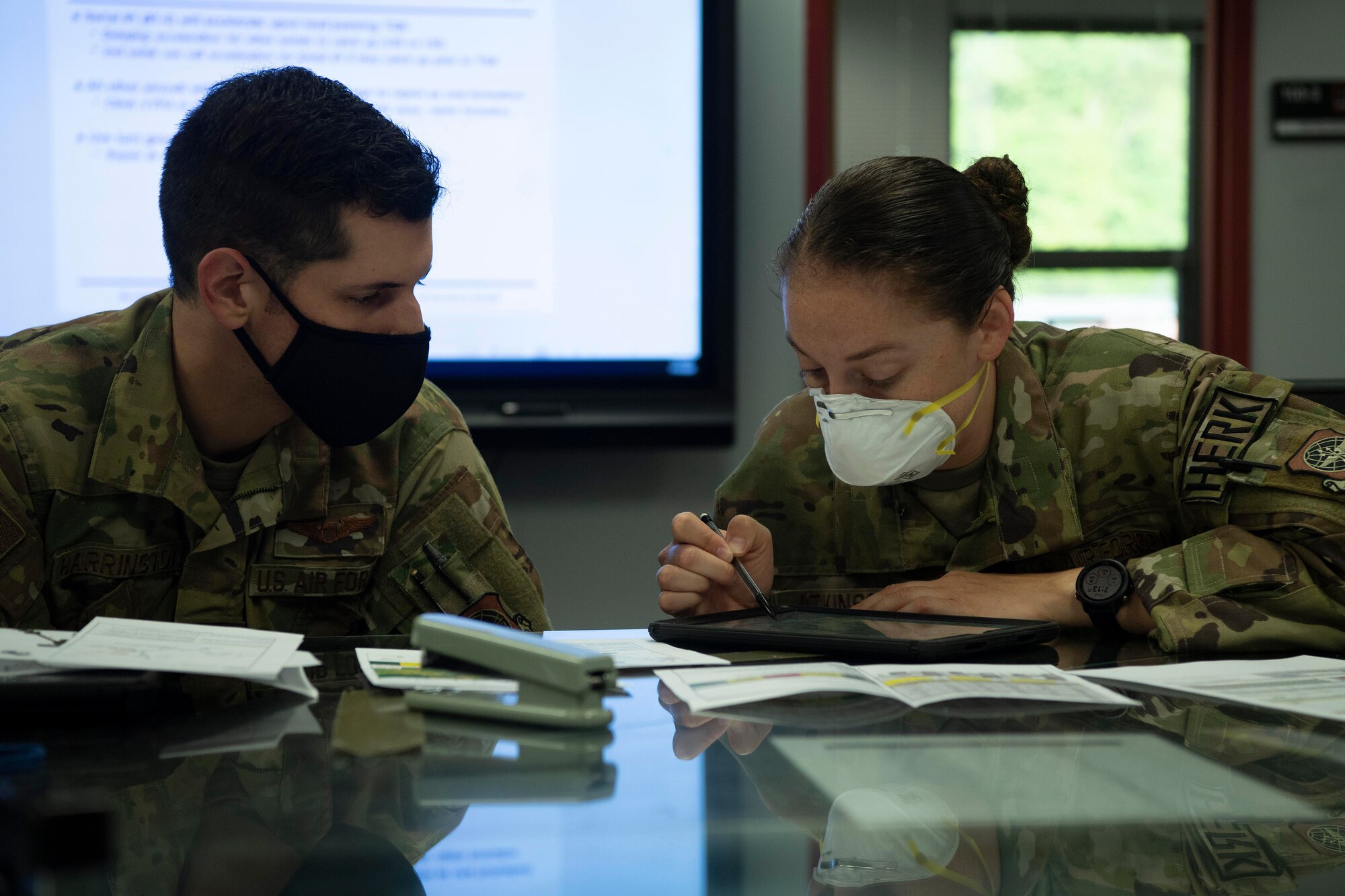 Capt. Justin Harrington and Capt. Maddie Atkinson, 41st Airlift Squadron pilots, prepare for crew briefs before the Herk Nation Stampede at Little Rock Air Force Base, Arkansas, July 14, 2020.