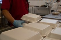 Marines and employees with the Camp Foster Mess Hall 488 prepare to-go chow for Marines on restricted of movement (ROM) at Camp Foster, Okinawa, Japan, July 9, 2020. All inbound personnel to Okinawa must ROM for 14 days. (U.S. Marine Corps photo by Lance Cpl. Zachary Larsen)