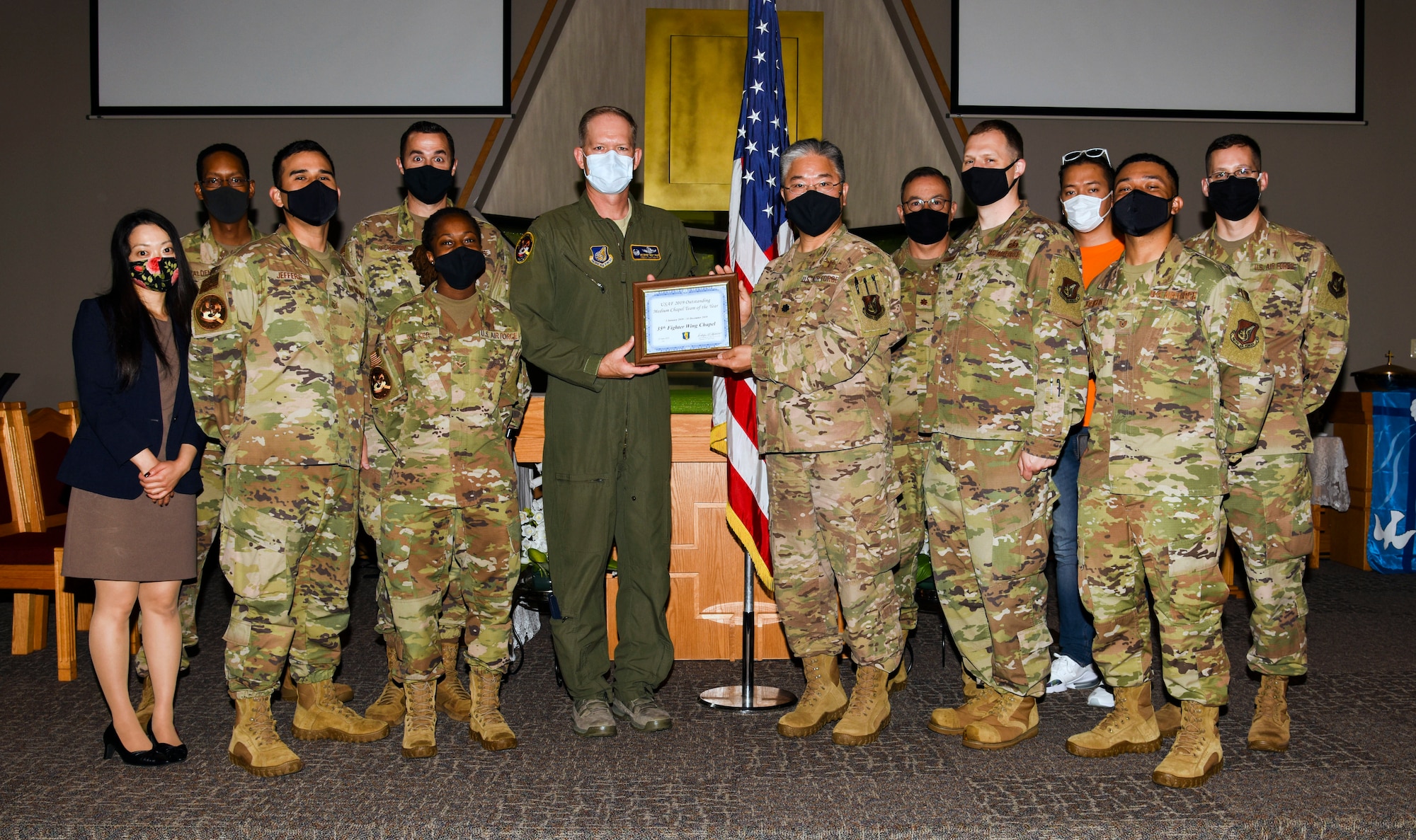 U.S. Air Force Col. Kristopher Struve, 35th Fighter Wing former commander, presents a certificate of recognition honoring the Misawa Chapel Team for winning the Terence P. Finnegan Award at Misawa Air Base, Japan, June 23, 2020. Named after Maj. Gen. Terence P. Finnegan, the award recognizes the Air Force Outstanding Medium Chapel Team of the Year. (U.S. Air Force photo by Tech. Sgt. Timothy Moore)